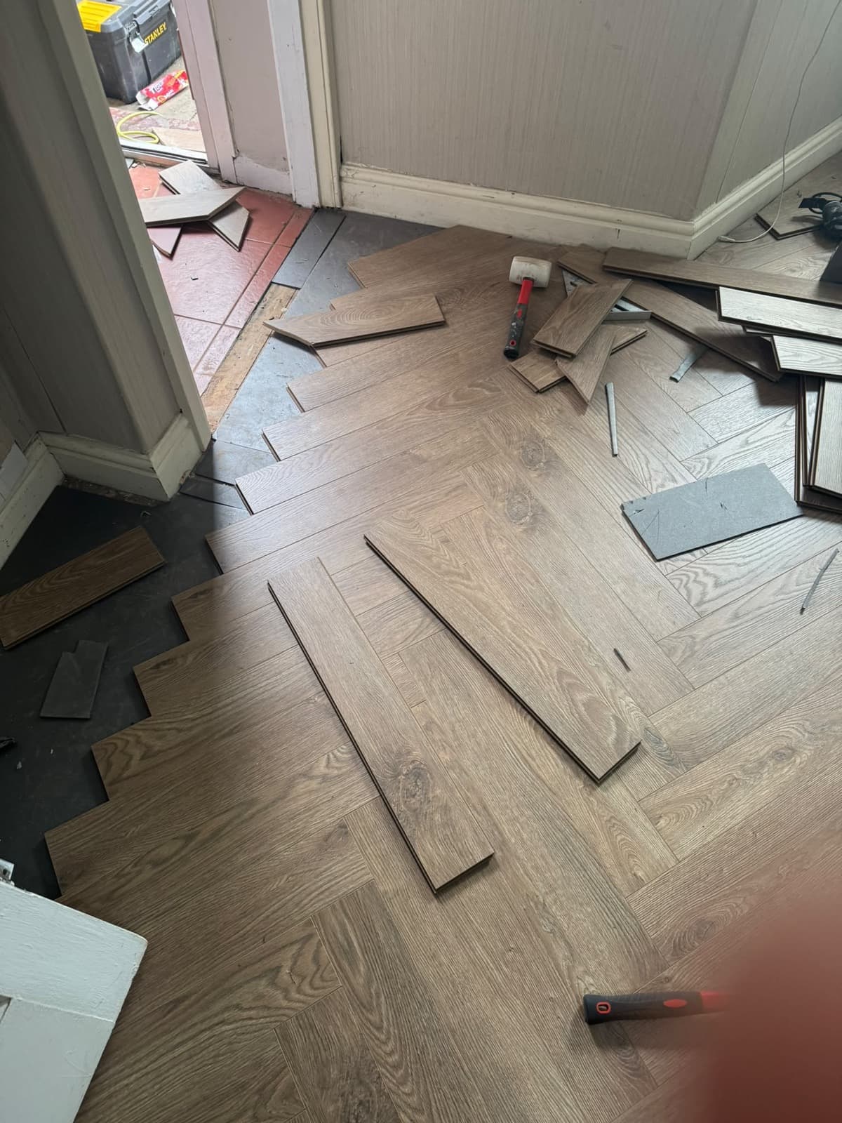 Herringbone laminate flooring being installed by CH Developments in Birmingham