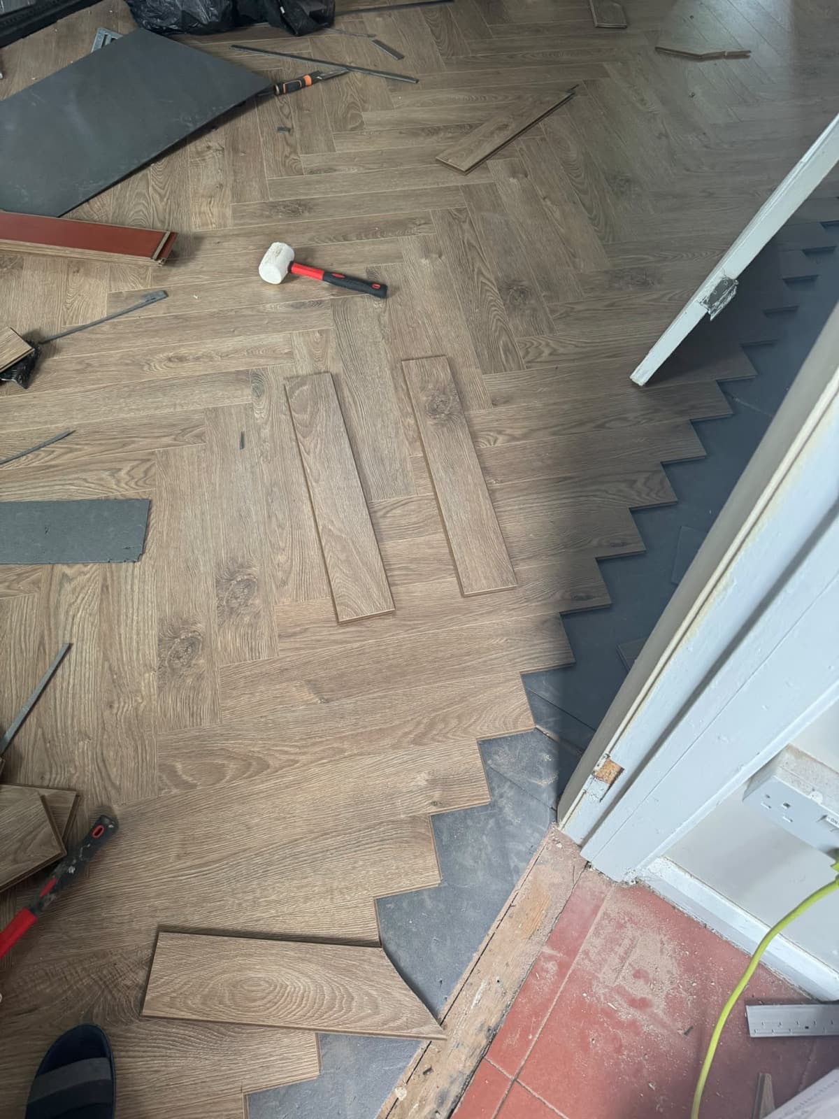 Laminate flooring laid in a herringbone pattern by CH Developments in Birmingham