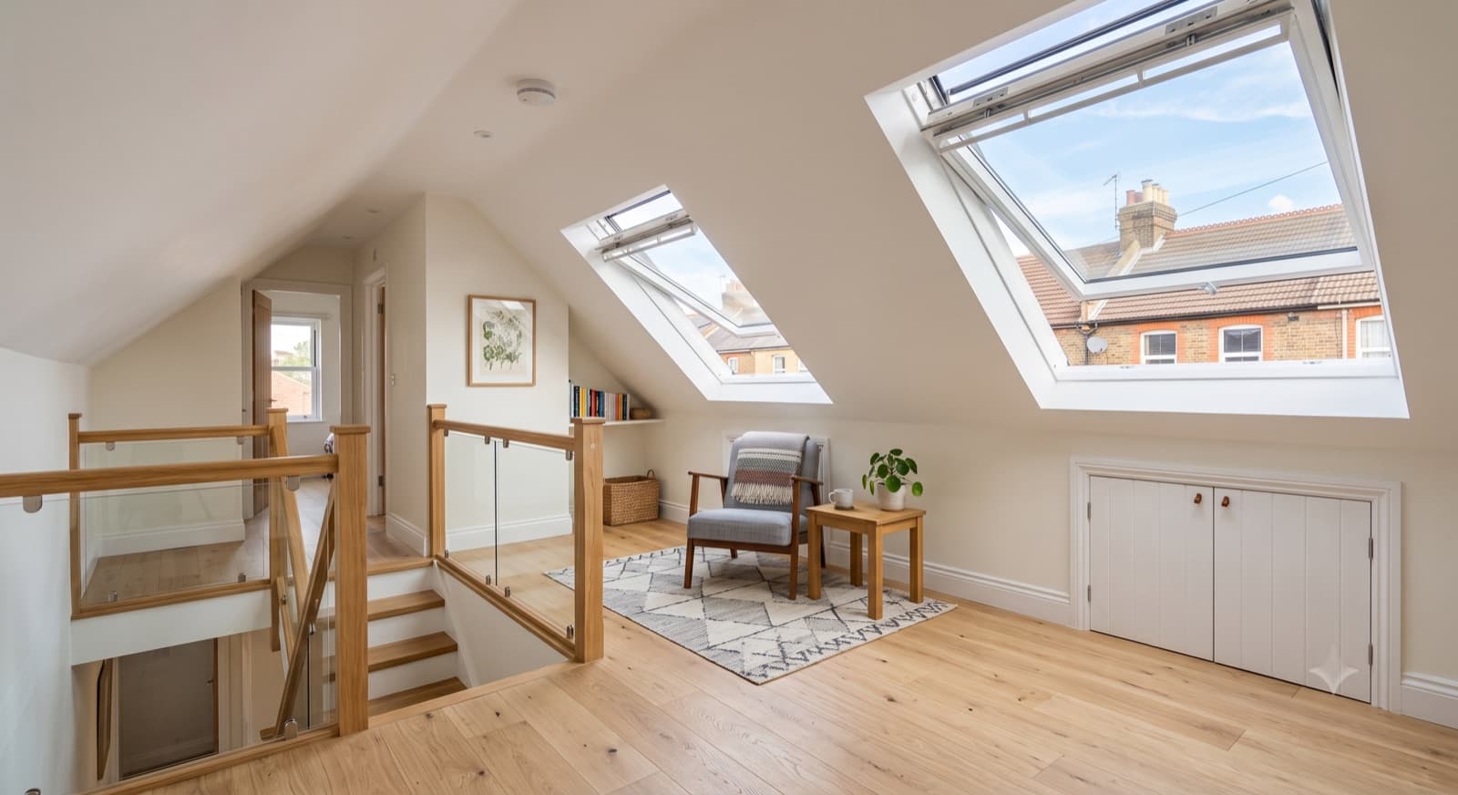 Loft Conversions in Redditch: a bright finished loft conversion with Velux roof windows, sloped ceilings and an engineered-wood floor